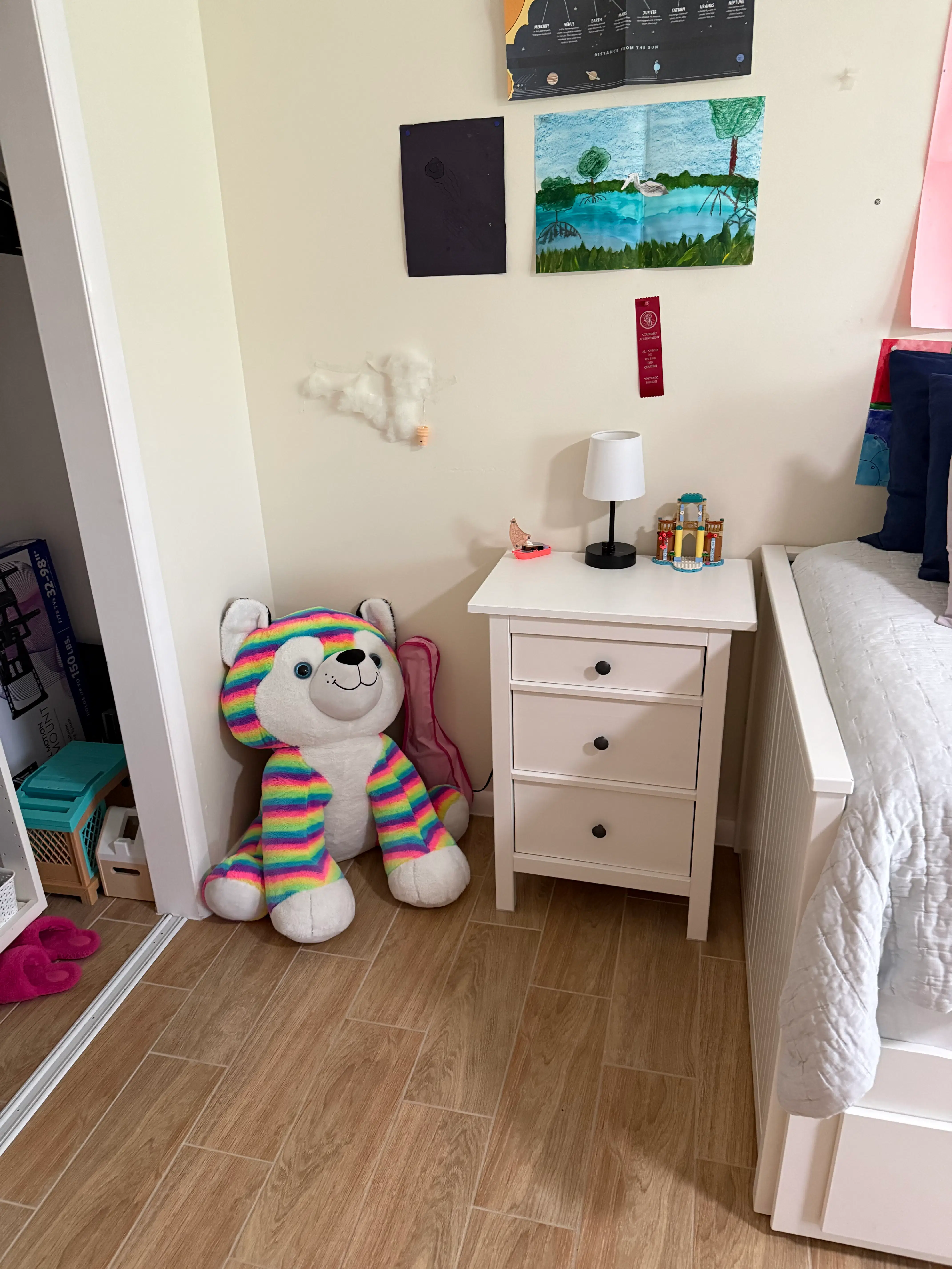 A child’s bedroom with a clear nightstand, lamp, and favorite plush toy arranged for a calmer bedtime routine