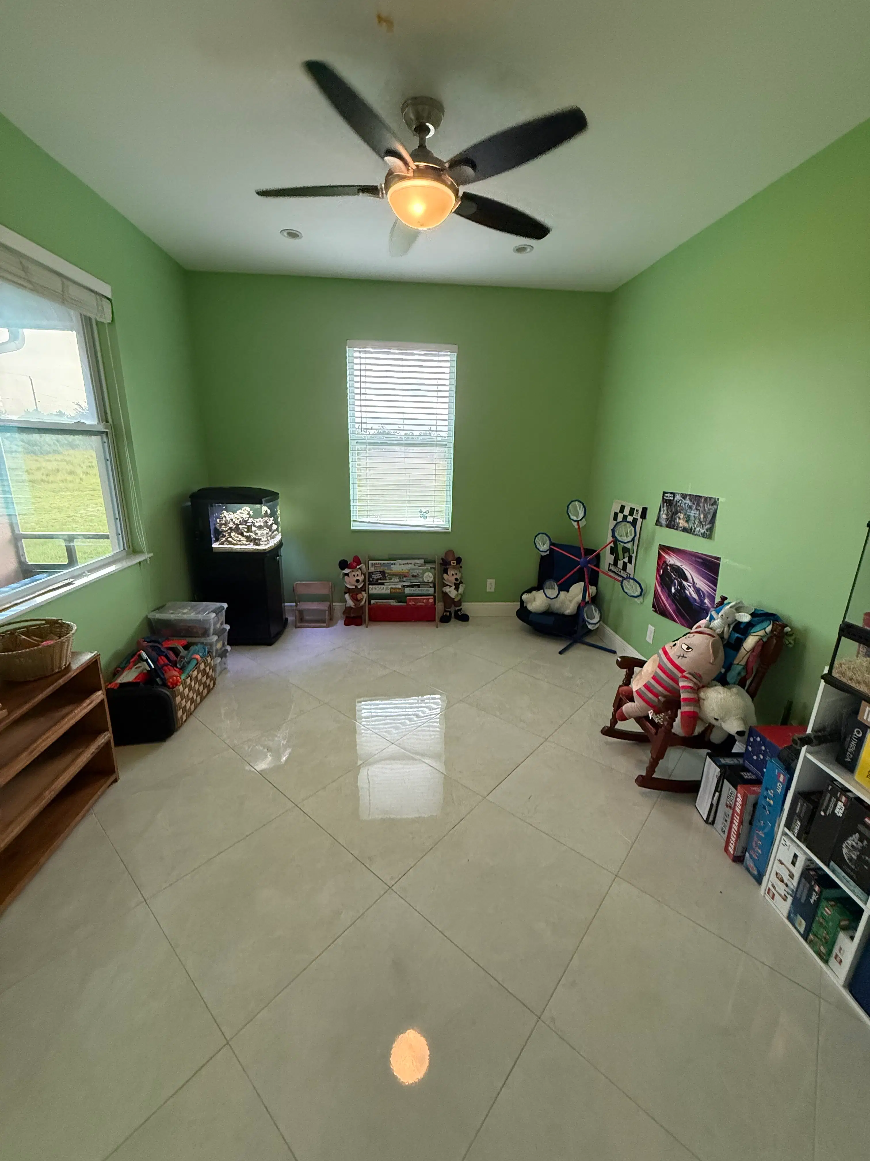 The same playroom with a clear floor, open shelves, and toys grouped where they are easier to reach and return